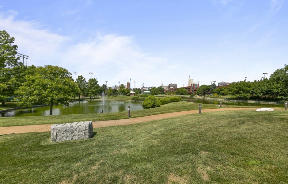 Large park with green grass looking towards St. Louis